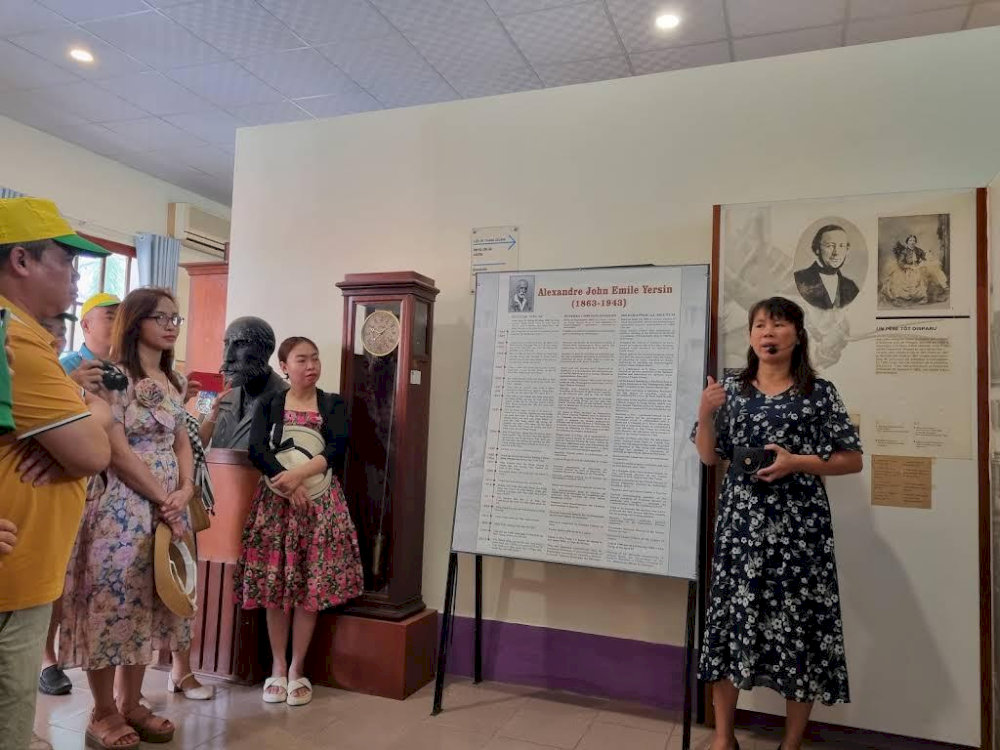 Visitors listen attentively as a guide shares stories about Dr. Alexandre Yersin’s life and contributions at the museum